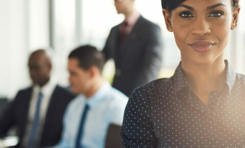 Young business owner in office with employees