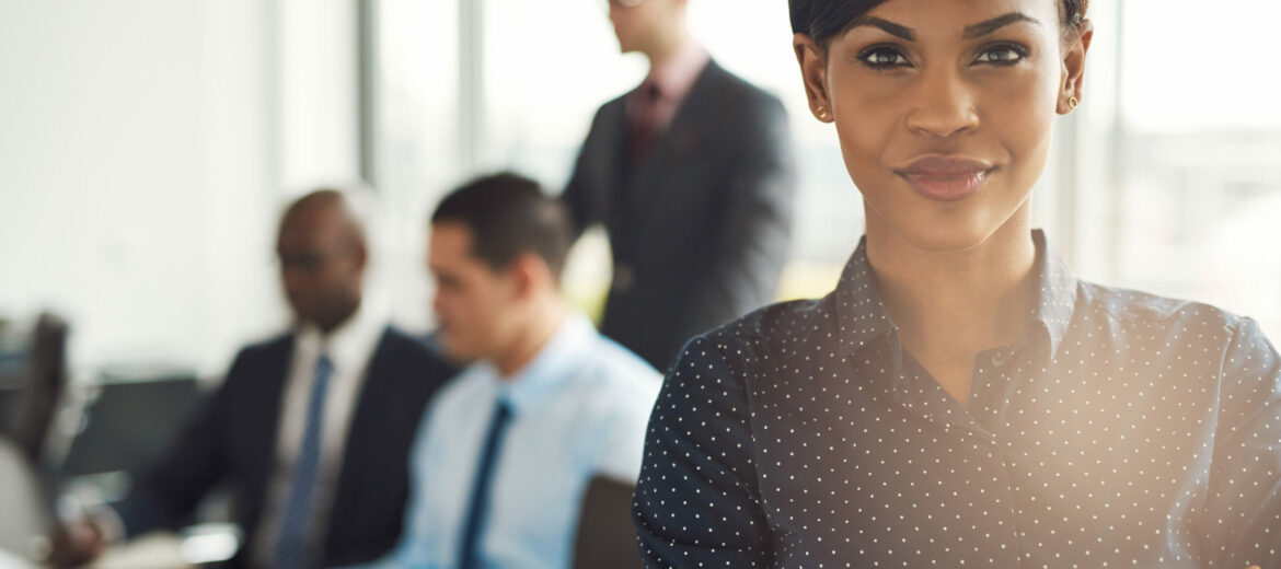 Young business owner in office with employees